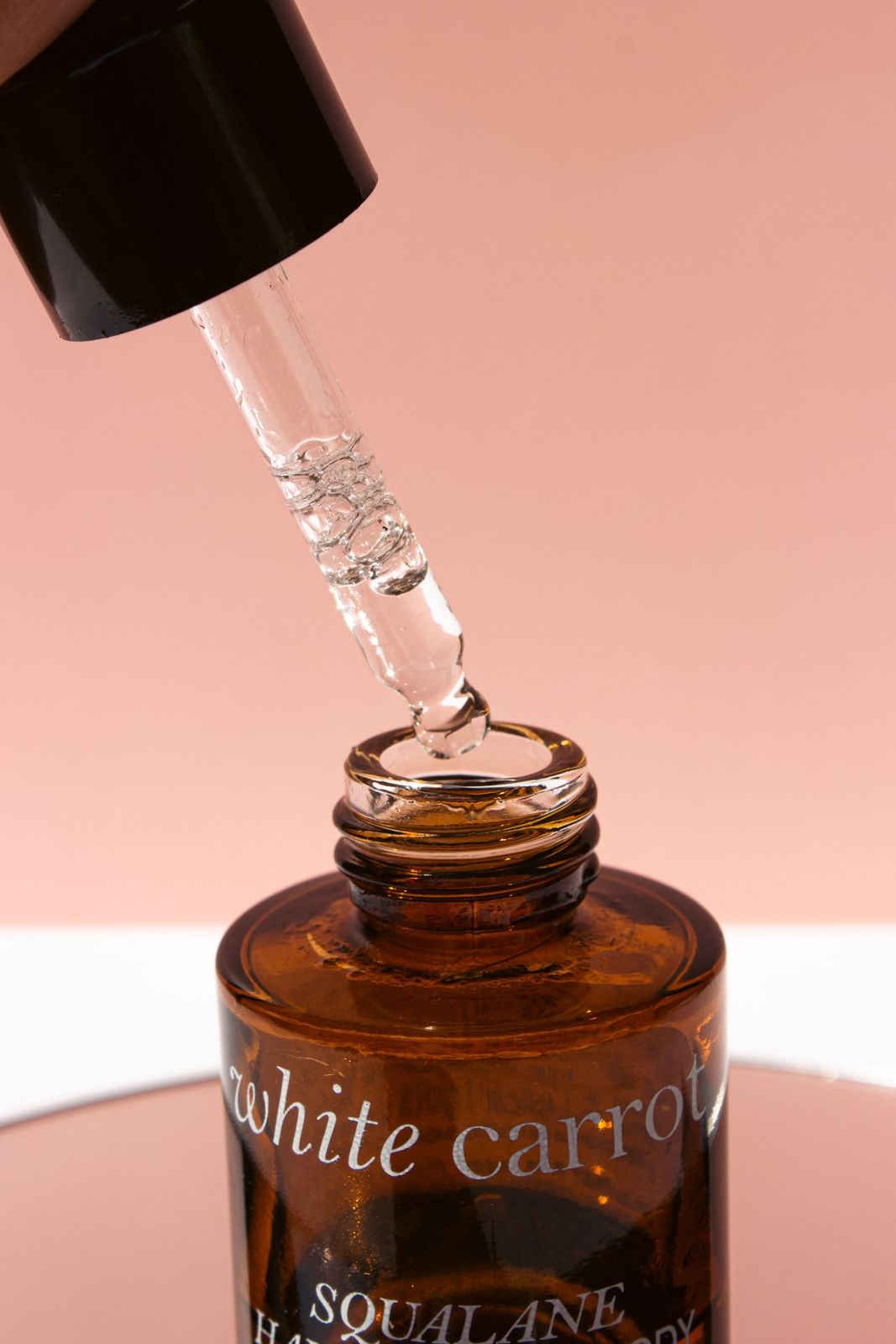 A glass dropper bottle of facial serum from the studio's refillable range
