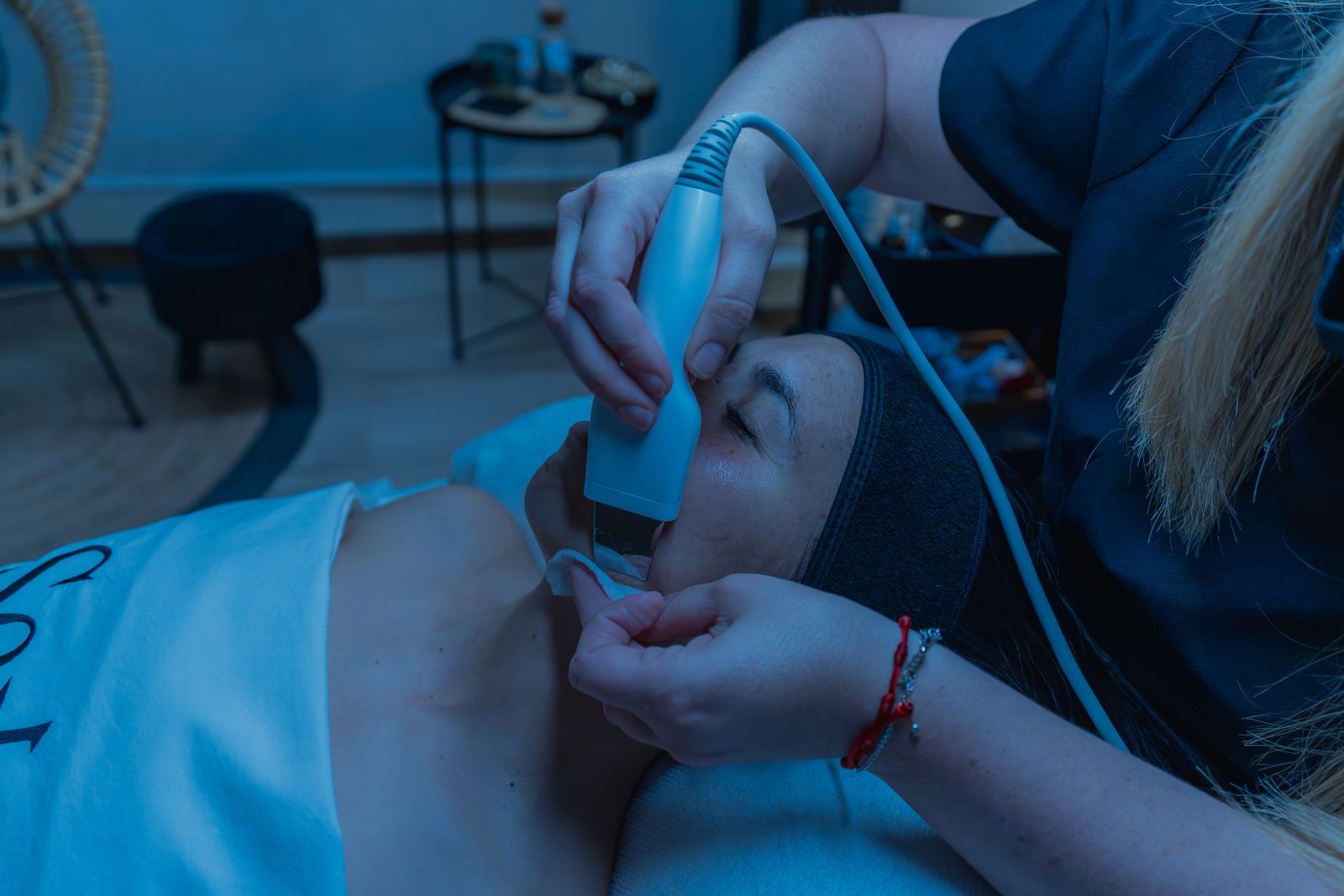 A therapist using a handheld device during an advanced resurfacing treatment