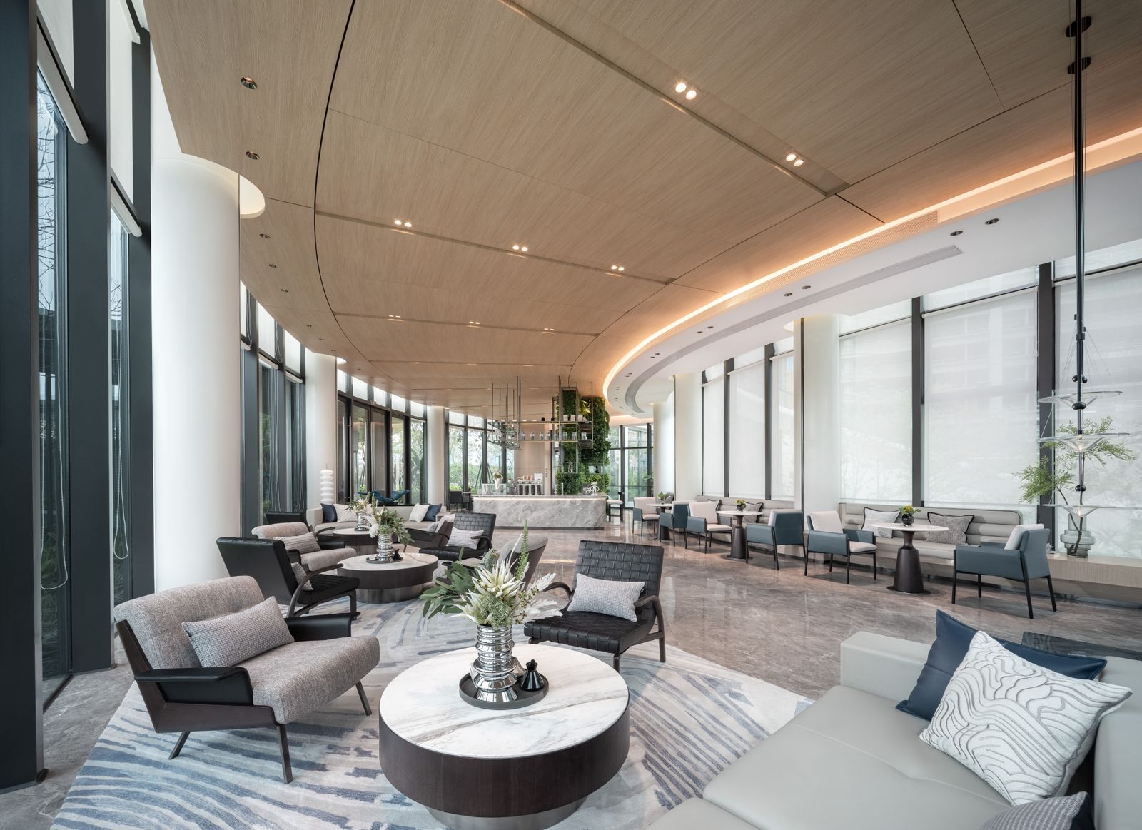 The marble-floored lobby lounge at The Meridian with mirrored columns and low emerald armchairs