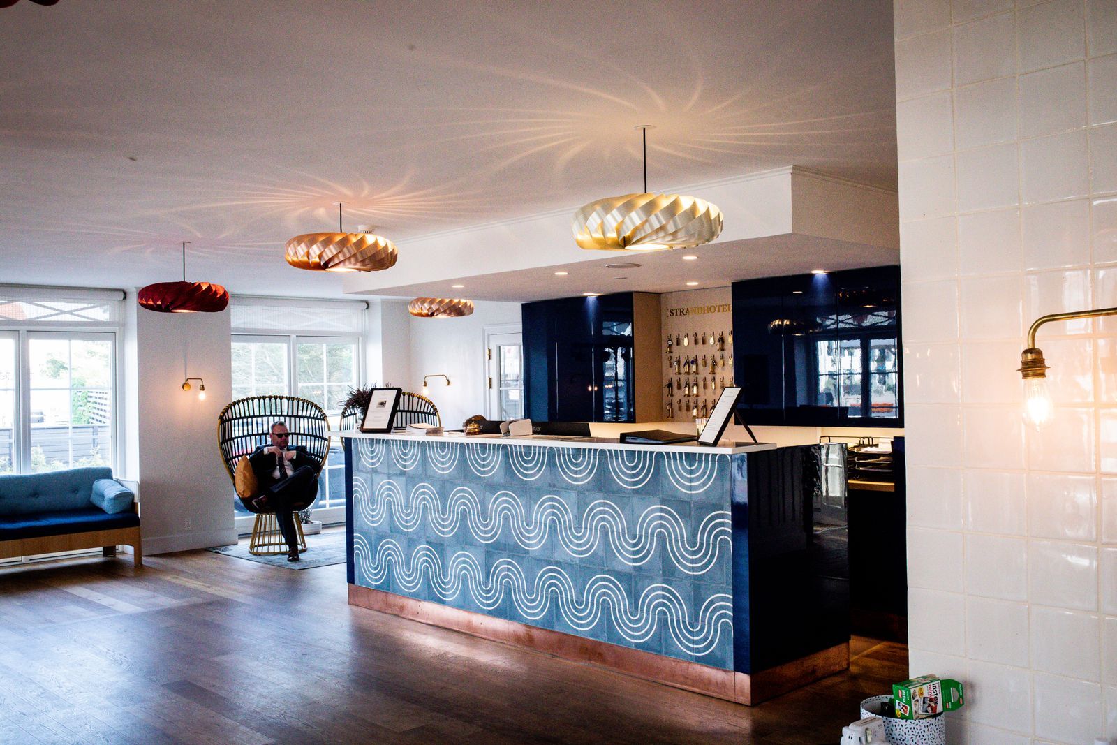 The reception desk at The Meridian, brass fittings and a wall of pigeonholes behind