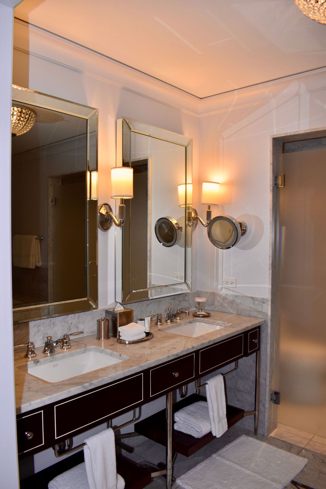 A spa changing room at The Meridian with twin basins, marble tops and a tall mirror