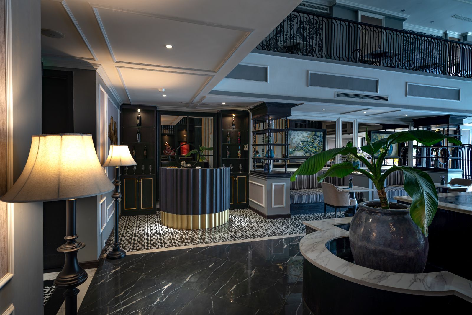 A superior room at The Meridian with a velvet sofa, writing desk and garden doors