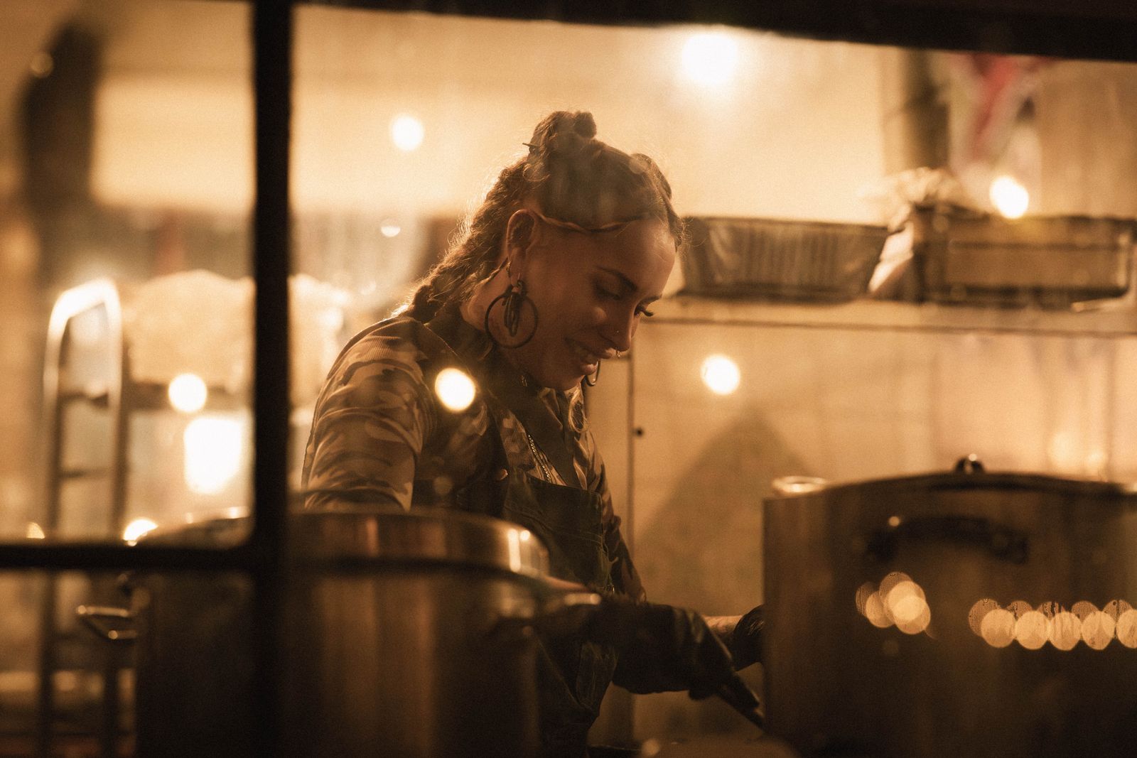 Chef Elena Marchetti finishing a plate at the pass before service