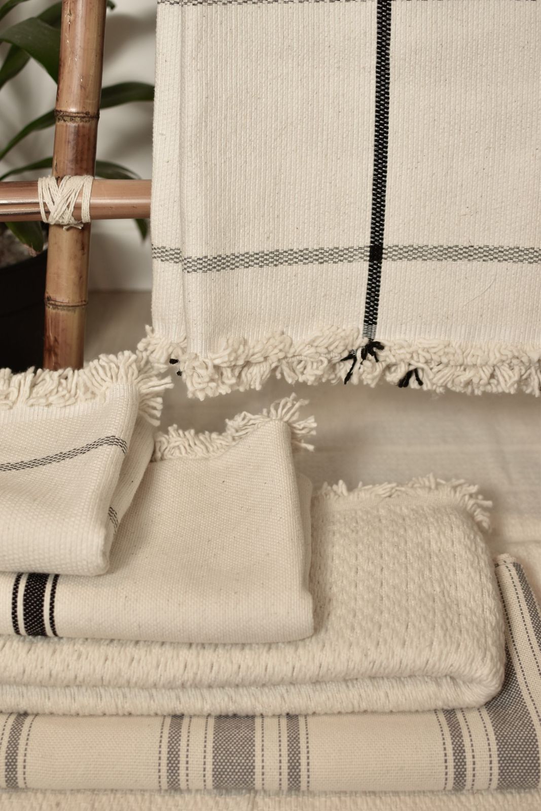 A stack of washed linen in oatmeal and clay tones